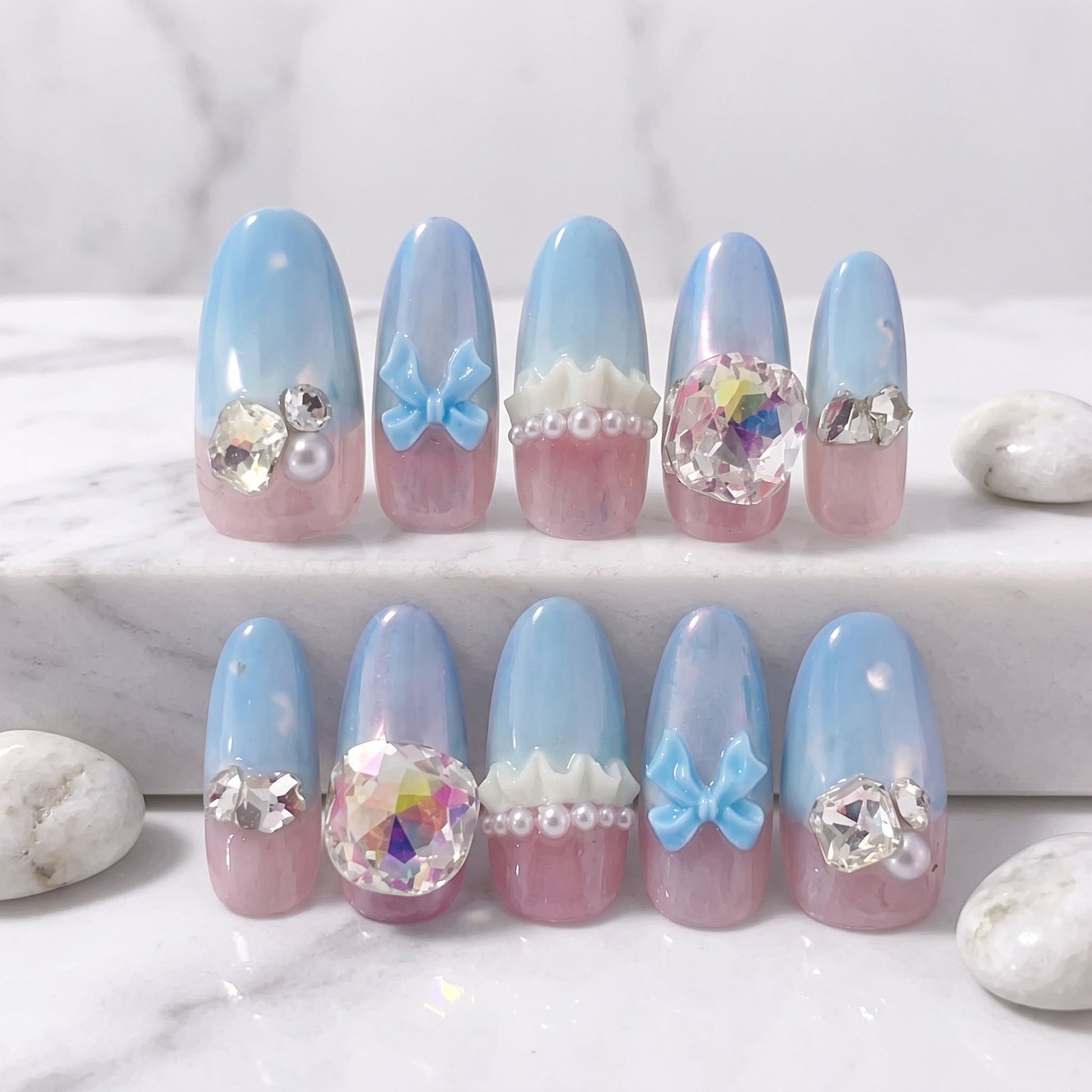 Baby Blue Princess press-on nails with pastel blue, pink, bows, pearls and large iridescent crystals