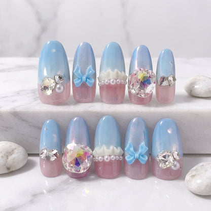 Baby Blue Princess press-on nails with pastel blue, pink, bows, pearls and large iridescent crystals