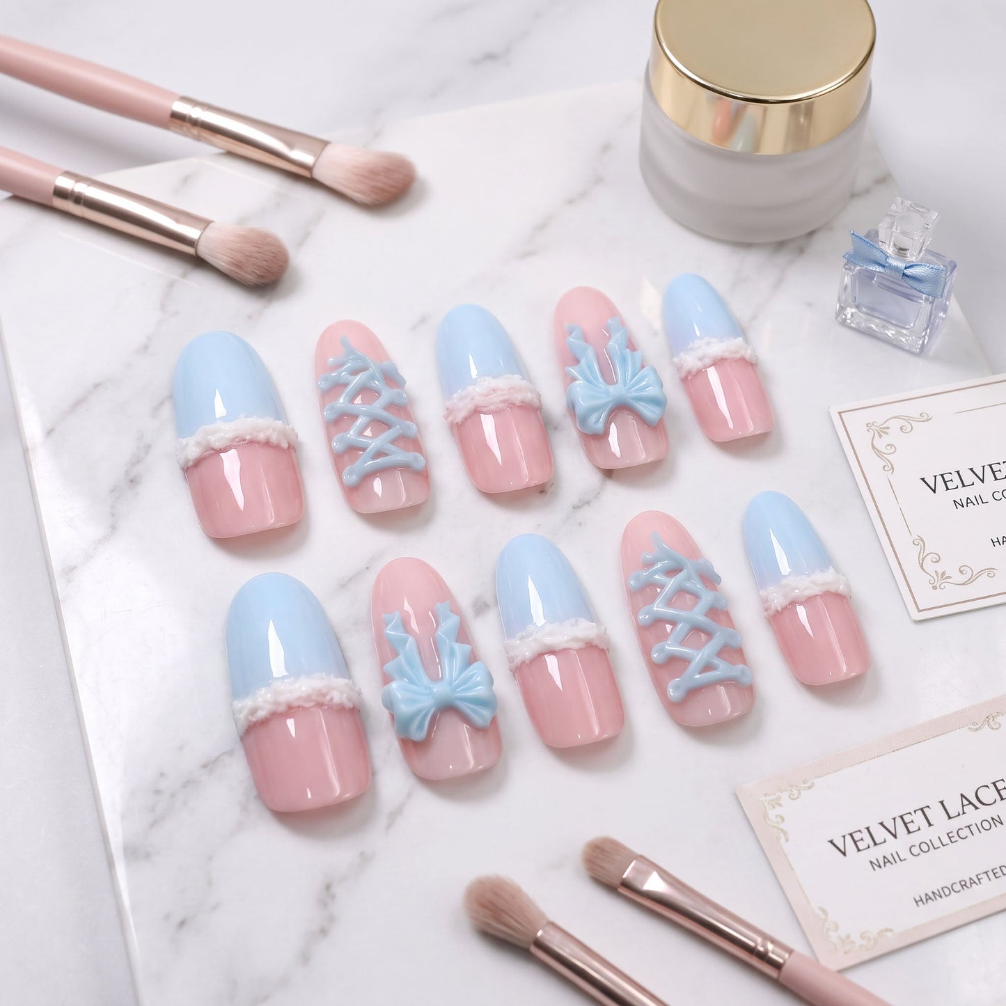 Bow Blue handmade press-on nails with pastel blue, blush pink, bow and lace-up details
