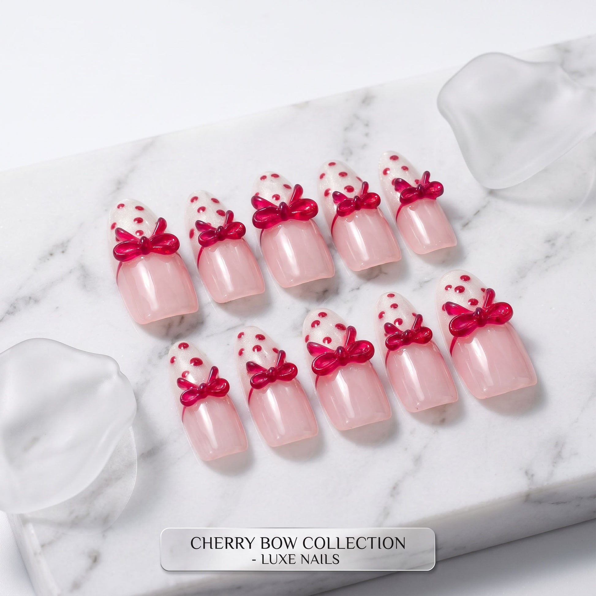 Cherry Bow handmade press-on nails with pale pink colour, white glitter tips and glossy red bows