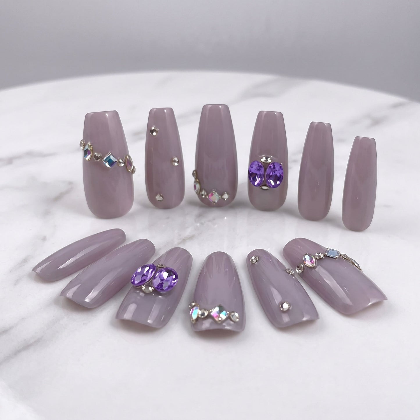 Indigo Pearl handmade press-on nails in muted lilac with purple gems and crystal accents
