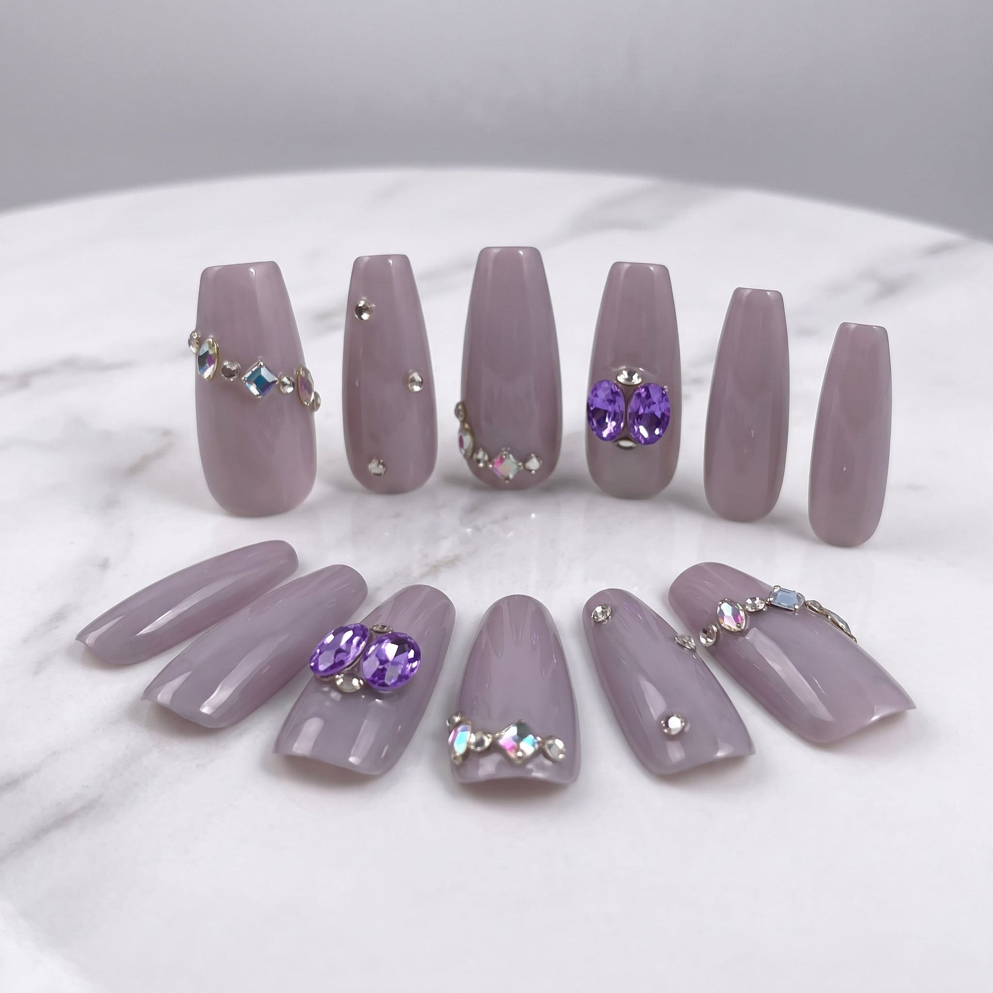 Indigo Pearl handmade press-on nails in muted lilac with purple gems and crystal accents